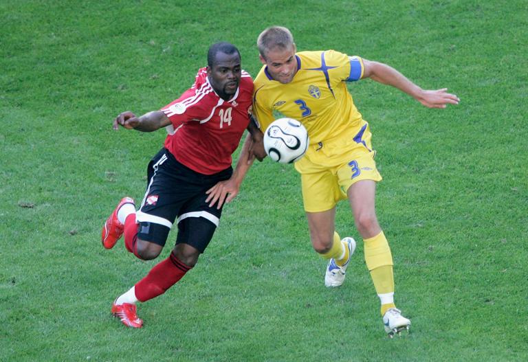 DORTMUND, GERMANY - JUNE 10: Stern John of Trinidad & Tobago battles with Olof Mellberg of Sweden during the FIFA World Cup Germany 2006 Group B match between Trinidad & Tobago and Sweden at the Stadium Dortmund on June 10, 2006 in Dortmund, Germany. (Photo by Christof Koepsel/Bongarts/Getty Images)